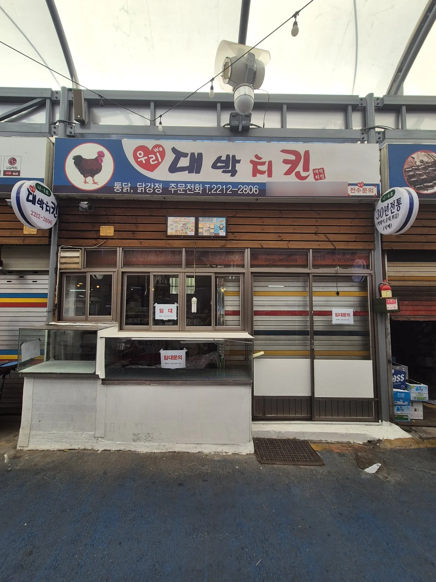 시장 안 — 임대 안내가 붙은 점포